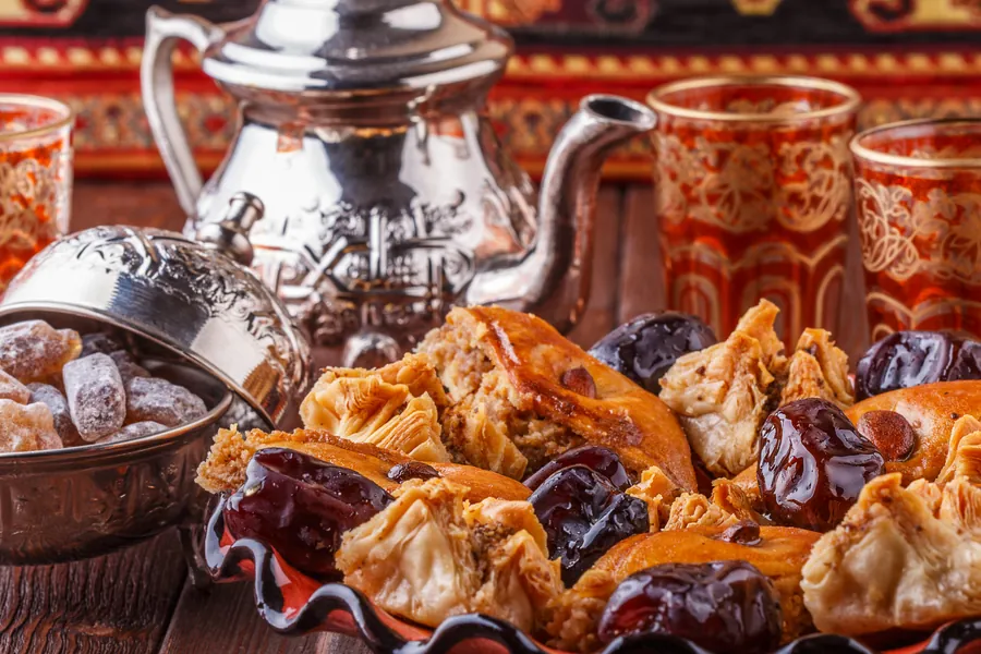 Moroccan mint tea in the traditional glasses with sweets.